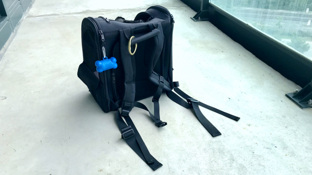 Detailed view of the Pecute dog carrier backpack showing its adjustable straps and handle.